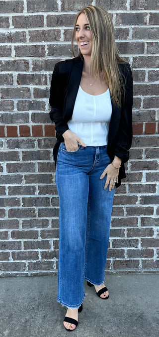 Sleeveless ribbed corset-style crop top in beige, taupe, black, royal blue and hot pink with curved hem and body hugging fit