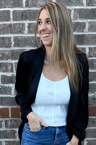 Sleeveless ribbed corset-style crop top in beige, taupe, black, royal blue and hot pink with curved hem and body hugging fit