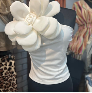 White one shoulder tank top with large floral accent on the shoulder with a fitted silhouette
