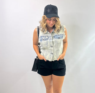 Womens sleeveless denim vest with raw hem and sparkling rhinestone embellishments, Perfect piece for concerts and downtown Nash.