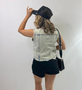 Womens sleeveless denim vest with raw hem and sparkling rhinestone embellishments, Perfect piece for concerts and downtown Nash.