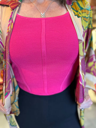 Sleeveless ribbed corset-style crop top in beige, taupe, black, royal blue and hot pink with curved hem and body hugging fit