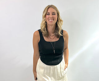 Sleeveless ribbed corset-style crop top in beige, taupe, black, royal blue and hot pink with curved hem and body hugging fit