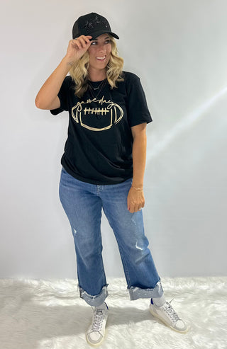 Black graphic t shirt with gold football and cursive game day design, perfect for team spirit and fanwear