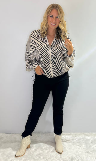 Zip Front bomber style jacket with black and white stripes, front pockets, and adjustable drawstring waist in lightweight polyester fabric