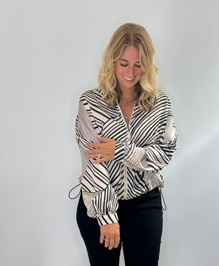 Zip Front bomber style jacket with black and white stripes, front pockets, and adjustable drawstring waist in lightweight polyester fabric