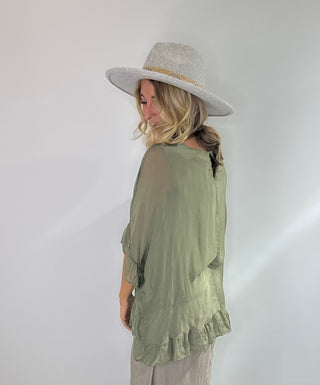 Sage Green oversized silk blouse with ruffle short sleeves, ruffle hem, and back keyhole button closure