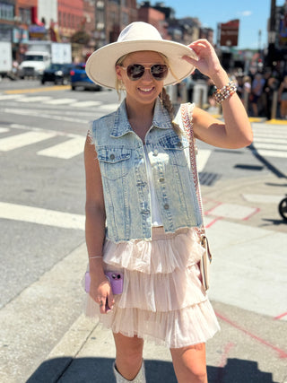 Womens sleeveless denim vest with raw hem and sparkling rhinestone embellishments, Perfect piece for concerts and downtown Nash.