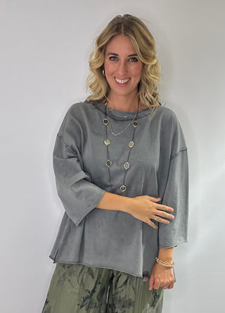 Oversized slate gray cotton top with exposed stitching and 3/4 length sleeve tee