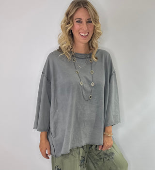 Oversized slate gray cotton top with exposed stitching and 3/4 length sleeve tee