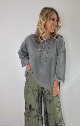 Oversized slate gray cotton top with exposed stitching and 3/4 length sleeve tee