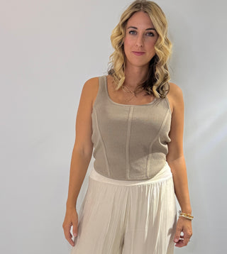 Sleeveless ribbed corset-style crop top in beige, taupe, black, royal blue and hot pink with curved hem and body hugging fit