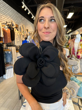 Black one shoulder tank top with large floral accent on the shoulder with a fitted silhouette