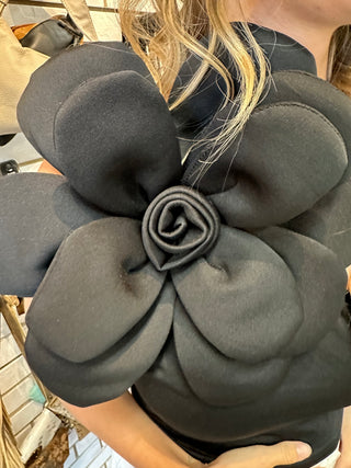 Black one shoulder tank top with large floral accent on the shoulder with a fitted silhouette