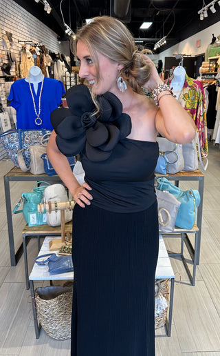 Black one shoulder tank top with large floral accent on the shoulder with a fitted silhouette
