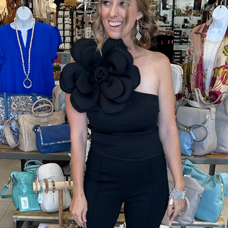 Black one shoulder tank top with large floral accent on the shoulder with a fitted silhouette