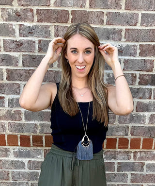 Sleeveless ribbed corset-style crop top in beige, taupe, black, royal blue and hot pink with curved hem and body hugging fit