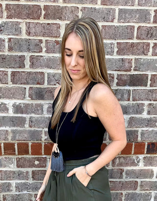 Sleeveless ribbed corset-style crop top in beige, taupe, black, royal blue and hot pink with curved hem and body hugging fit