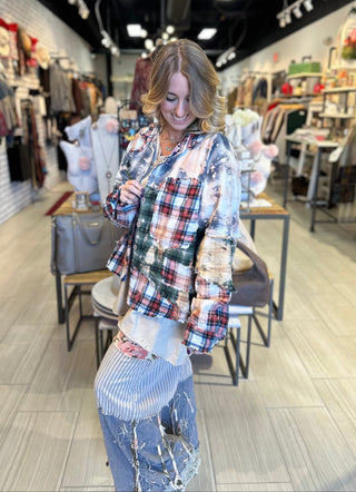 Handcrafted reversible patchwork flannel jacket with quilt inspired panels in blue, red, and earth tones with zigzag stitching, inside features a paisley pattern