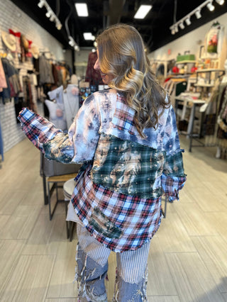 Handcrafted reversible patchwork flannel jacket with quilt inspired panels in blue, red, and earth tones with zigzag stitching, inside features a paisley pattern