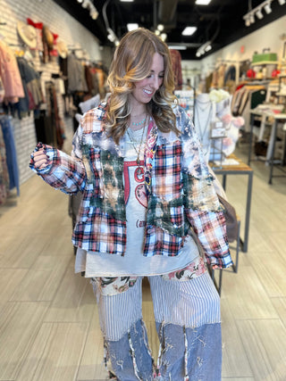 Handcrafted reversible patchwork flannel jacket with quilt inspired panels in blue, red, and earth tones with zigzag stitching, inside features a paisley pattern