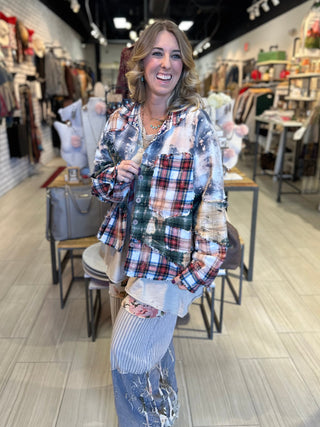 Handcrafted reversible patchwork flannel jacket with quilt inspired panels in blue, red, and earth tones with zigzag stitching, inside features a paisley pattern