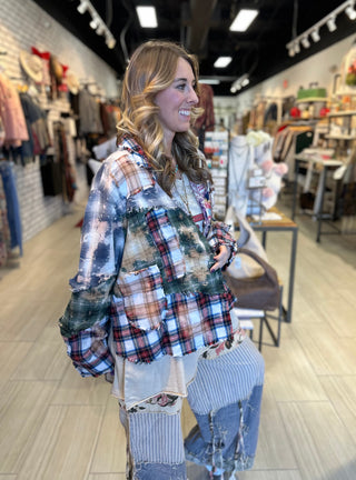 Handcrafted reversible patchwork flannel jacket with quilt inspired panels in blue, red, and earth tones with zigzag stitching, inside features a paisley pattern