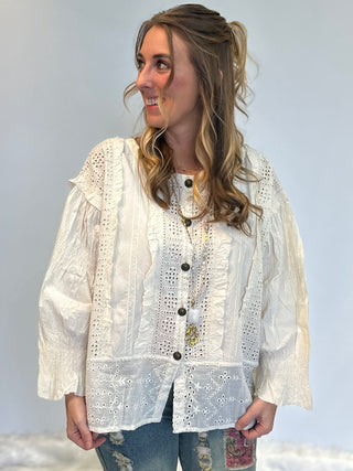White 100% cotton Schiffli eyelet blouse with ruffle detailing, front-open button design, and relaxed boho-chic fit