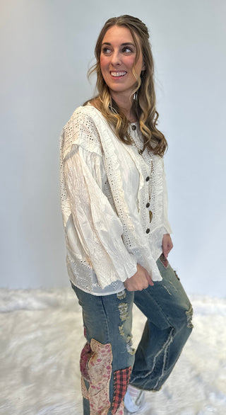 White 100% cotton Schiffli eyelet blouse with ruffle detailing, front-open button design, and relaxed boho-chic fit