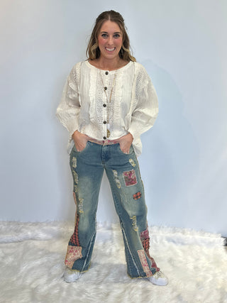 Distressed patchwork stretch denim pants with elastic waistband, loose fit, full-length silhouette and five pocket style