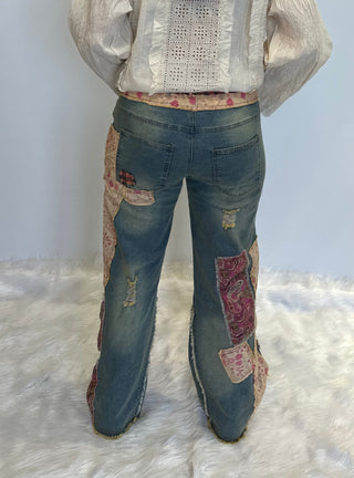 Distressed patchwork stretch denim pants with elastic waistband, loose fit, full-length silhouette and five pocket style