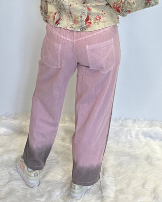 Lilac boho denim pants in 100% cotton with lace accents, brown ombre spray detail, elastic back waistband, and relaxed statement silhouette.