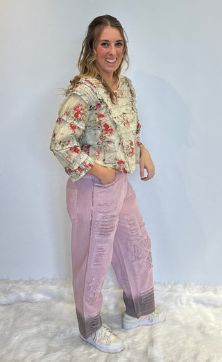 Lilac boho denim pants in 100% cotton with lace accents, brown ombre spray detail, elastic back waistband, and relaxed statement silhouette.