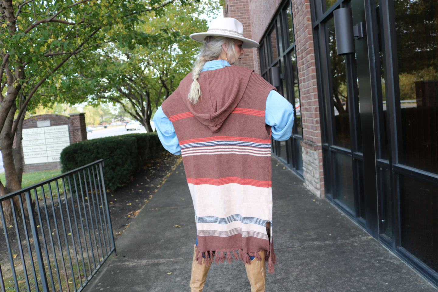 Long knit sweater poncho, cardigan, hooded, with tassel fringe at the bottom. Brown, cream, navy blue, red