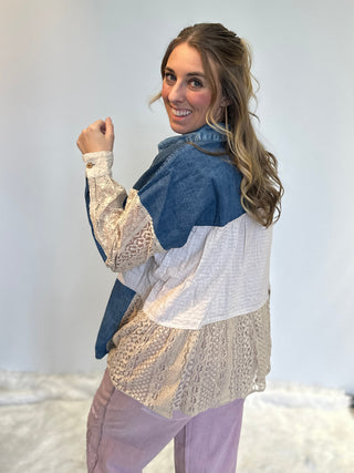 Mixed media denim shirt with lace patchwork, button-up front, long sleeves, and relaxed boho shirt-jacket fit.