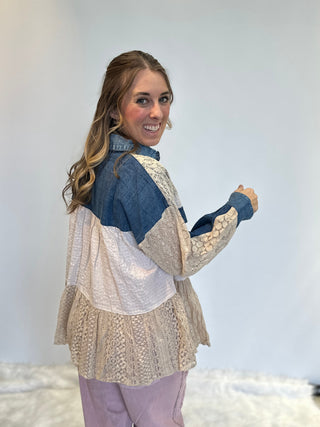 Mixed media denim shirt with lace patchwork, button-up front, long sleeves, and relaxed boho shirt-jacket fit.