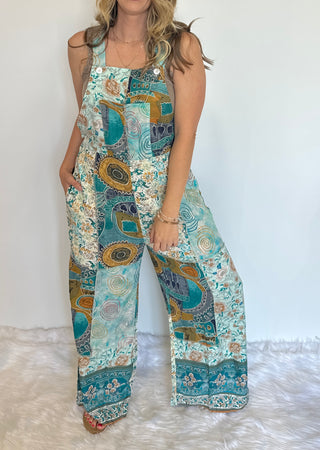 Boho patchwork jumpsuit with wide-leg silhouette in a colorful cotton-rayon blend, featuring adjustable straps, stretchy back, and pockets—vintage-inspired festival and beach outfit handcrafted in Nepal