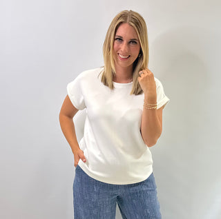 Women's cap sleeve top made from smooth, lightweight fabric with a relaxed, structured fit in ivory