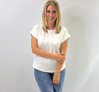 Women's cap sleeve top made from smooth, lightweight fabric with a relaxed, structured fit in ivory
