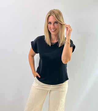 Women's cap sleeve top made from smooth, lightweight fabric with a relaxed, structured fit in black