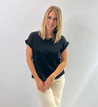 Women's cap sleeve top made from smooth, lightweight fabric with a relaxed, structured fit in black