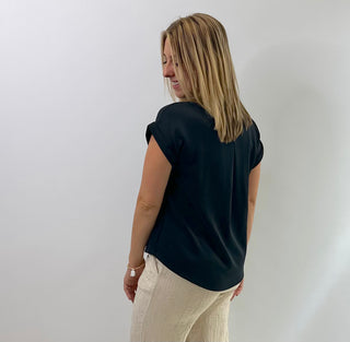 Women's cap sleeve top made from smooth, lightweight fabric with a relaxed, structured fit in black