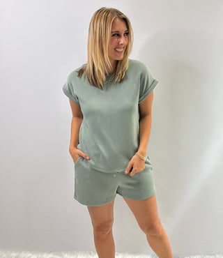 Women's cap sleeve top made from smooth, lightweight fabric with a relaxed, structured fit in sage green 