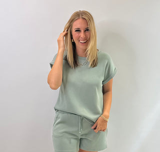 Women's cap sleeve top made from smooth, lightweight fabric with a relaxed, structured fit in sage green 