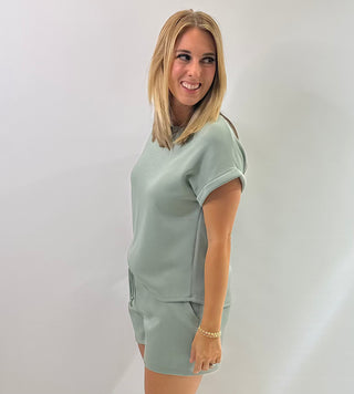 Women's cap sleeve top made from smooth, lightweight fabric with a relaxed, structured fit in sage green 