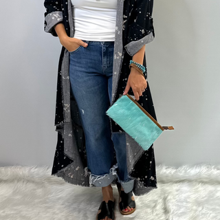 Teal genuine leather wristlet with zip closure and detachable wrist strap, featuring western inspired detailing by American Darling. 