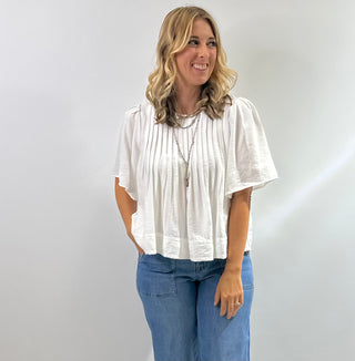 Womens white short sleeve peplum blouse with pin tuck detailing on the bodice with a flared hem