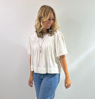 Womens white short sleeve peplum blouse with pin tuck detailing on the bodice with a flared hem