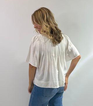 Womens white short sleeve peplum blouse with pin tuck detailing on the bodice with a flared hem