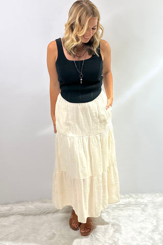 Sleeveless ribbed corset-style crop top in beige, taupe, black, royal blue and hot pink with curved hem and body hugging fit 